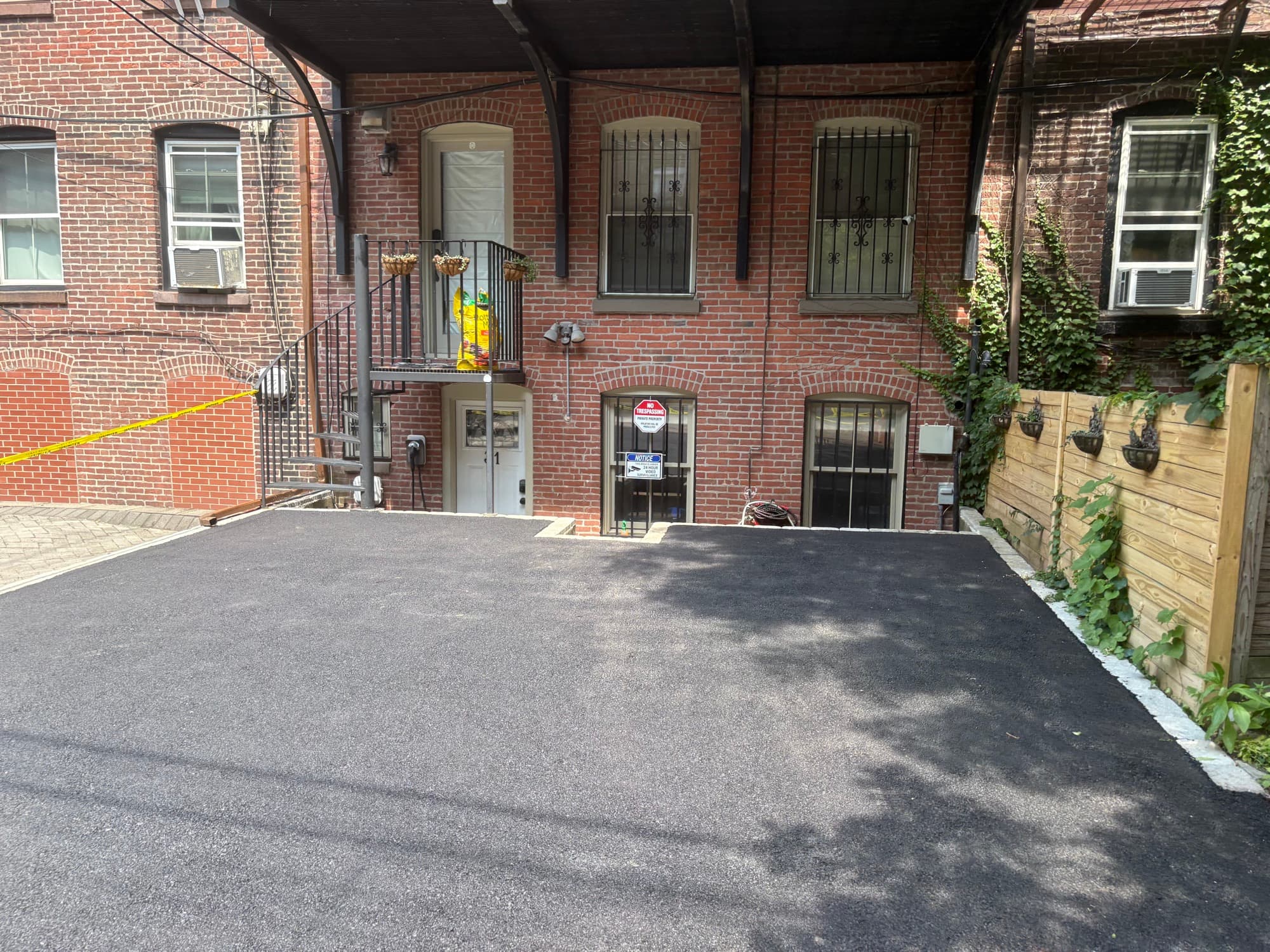 Finished driveway alongside a brick building